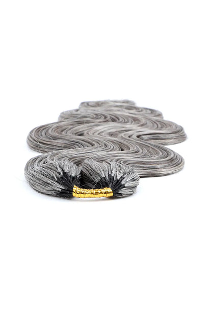 Detail of the ends of salt and pepper body wave feather crochet human hair 85 gray