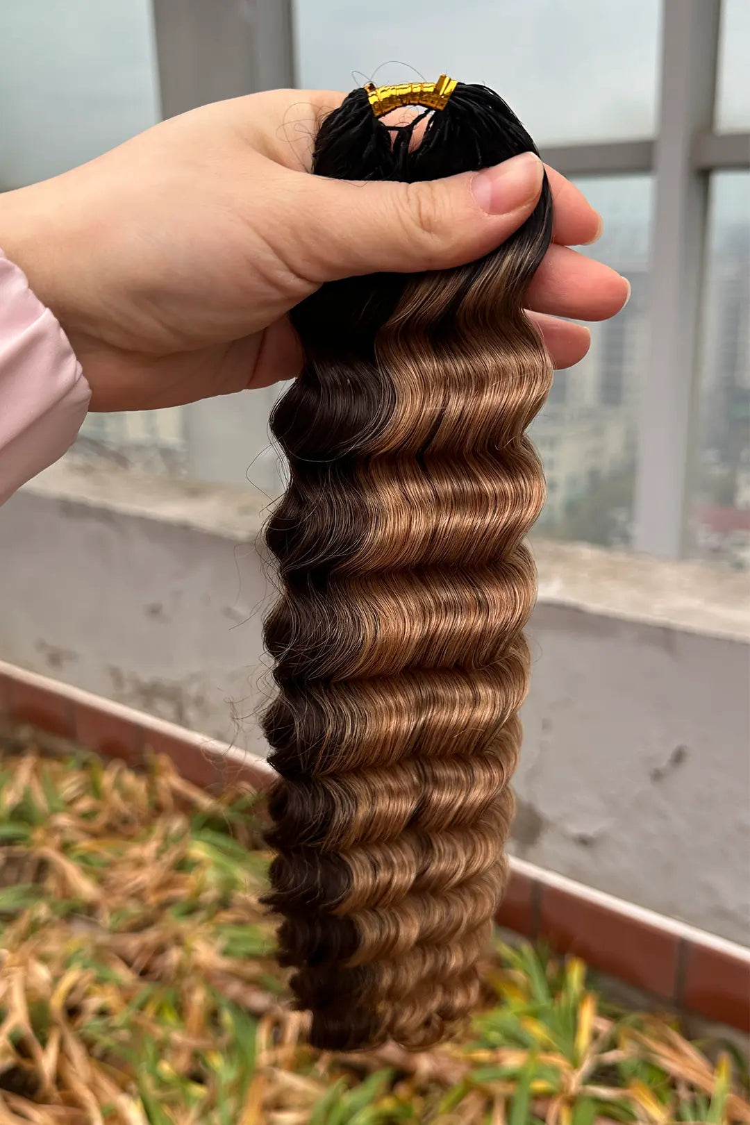 Outdoor picture of T natural black root piano color #4/#27 deep wave feather crochet human hair